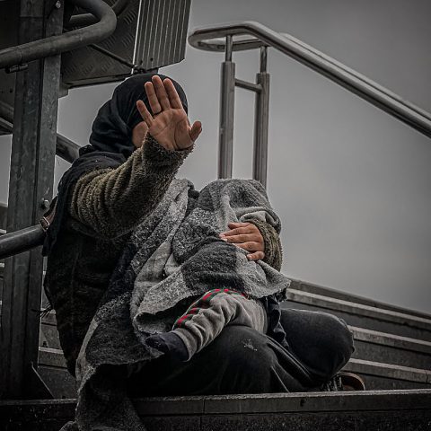 Syrian beggar with a baby in her arms