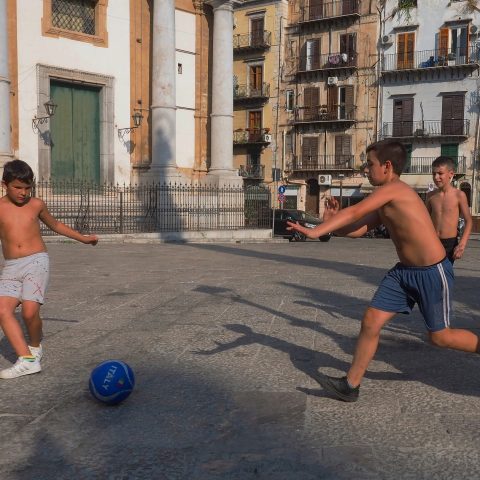 Children playing soccer on the street 1