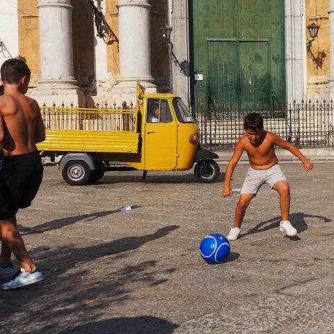 Children playing soccer on the street 2