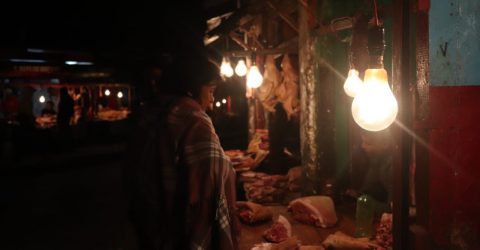 A woman looking the meat