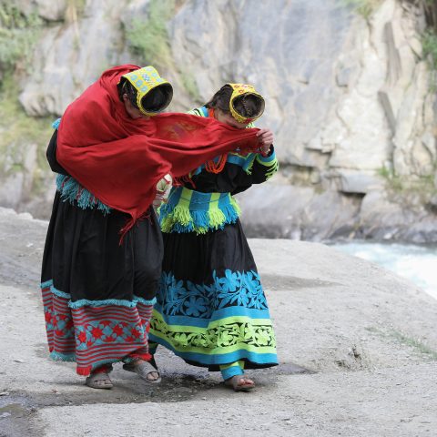 Shy Kalash girls hiding from the camera