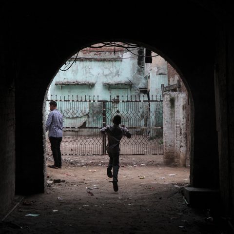 Boy runs through an alley inside the Walled City
