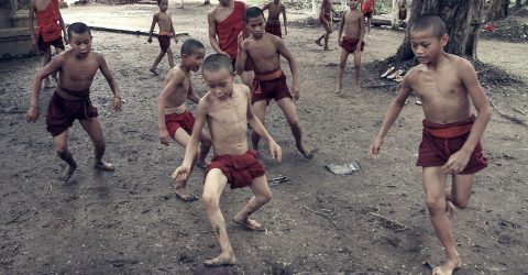 Boys from the Buddhist monastery playing football