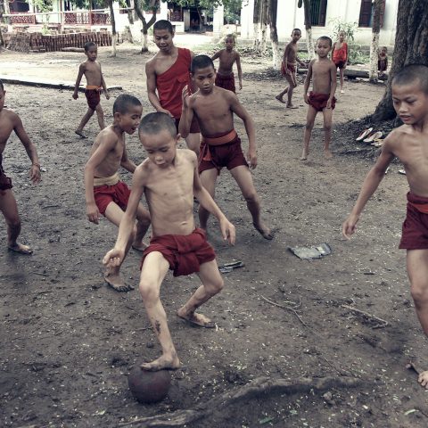 Boys from the Buddhist monastery playing football