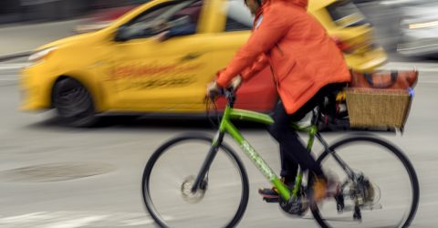 Cyclist and delivery car rushing