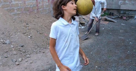 Street scene of a boy in a backyard in Etchmiadzin, Armenia