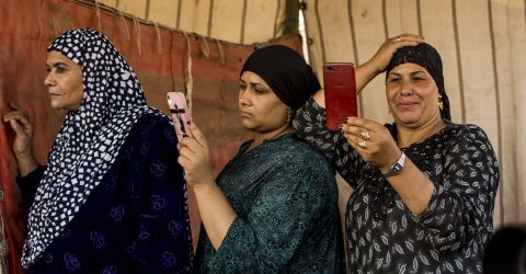 Three woman photograph a video for the people who dance on the anniversary of The Birth of Elsayed Albadwi