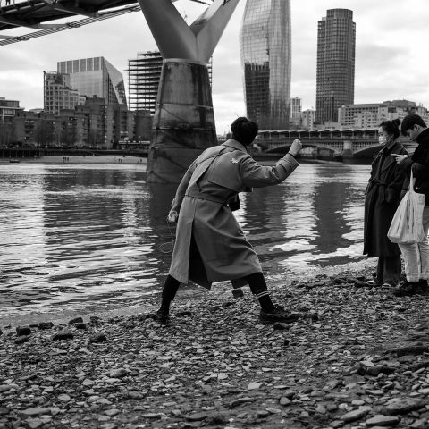 Guys playing with stones on the Thames